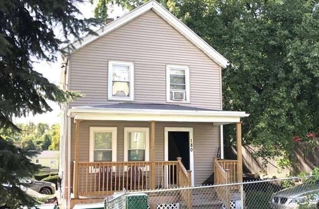 a view of a white house with large windows