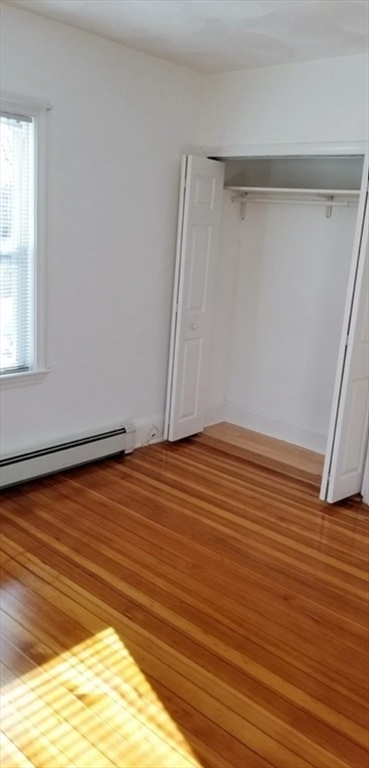 180 Myrtle Street, Unit 1 Lynn, MA 01905 - Photo 5 of 8 a view of empty room with wooden floor