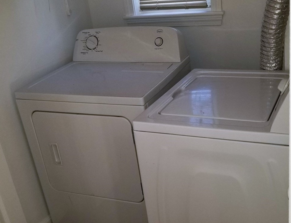 180 Myrtle Street, Unit 1 Lynn, MA 01905 - Photo 8 of 8 a utility room with dryer and washer