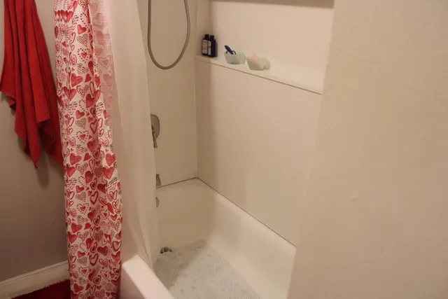 a view of a brick house with a yard and plants