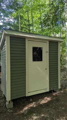 a view of a backyard with plants and lake view