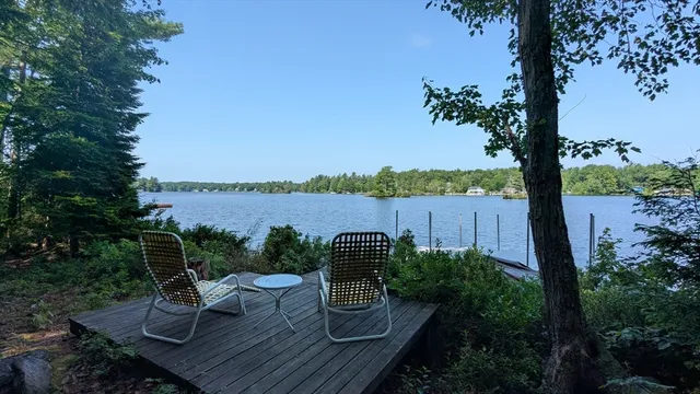 a view of a chairs and table on the wooden deck