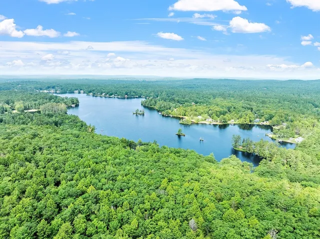 a view of a lake with a field