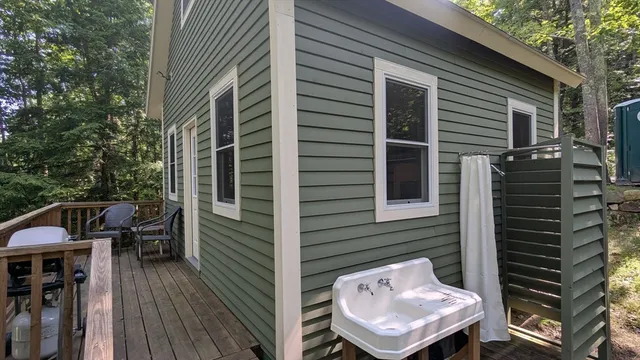 a view of a patio with chairs and large trees