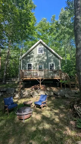 a view of a house with a yard balcony and sitting area