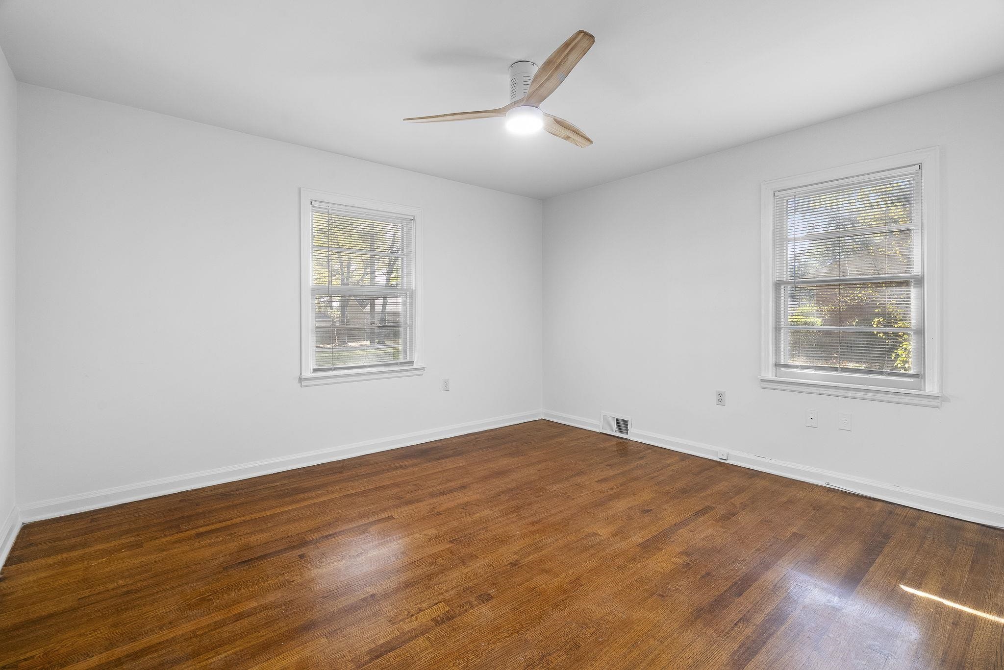 279 Quinn Road Collierville, TN 38017 - Photo 13 of 28 a view of an empty room with wooden floor and a window