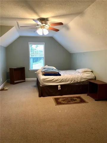a bedroom with bed and window