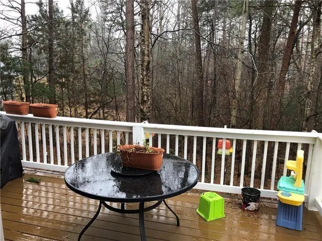 a view of a chair and table on the deck