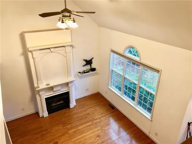 a view of empty room with window and fireplace