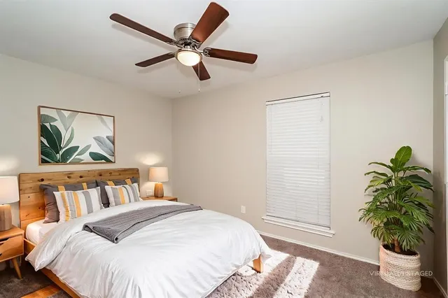 a bedroom with a bed and a potted plant
