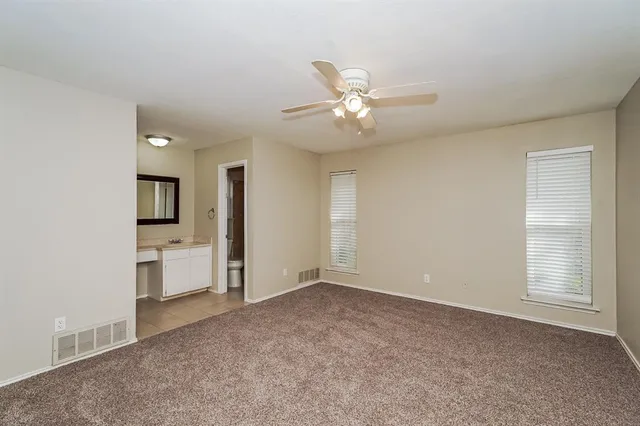 a view of a big room with windows and cabinet