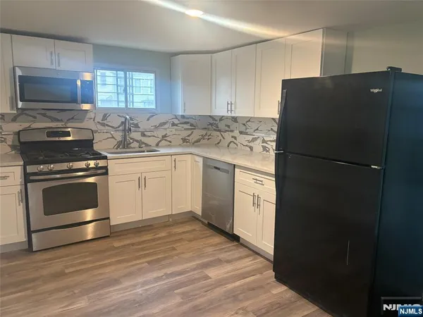 a kitchen with a refrigerator stove and microwave