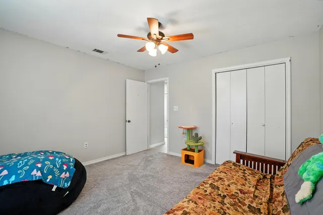 a bedroom with bed and a chandelier