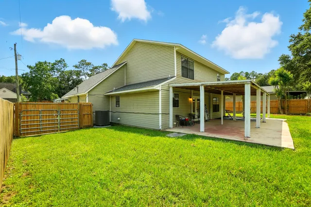 a view of a house with a yard and sitting area