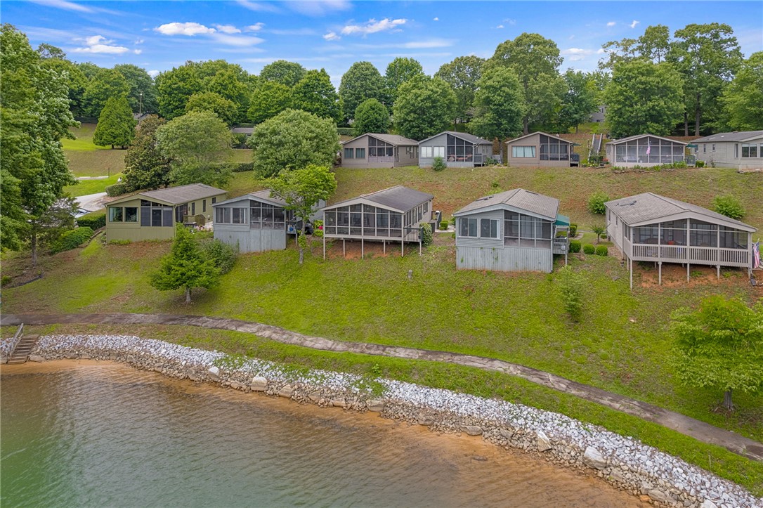 1230 Melton Road, Unit 25 West Union, SC 29696 - Photo 14 of 46 Lakeside living defines this community of charming cottages, each featuring a screened porch overlooking the water.