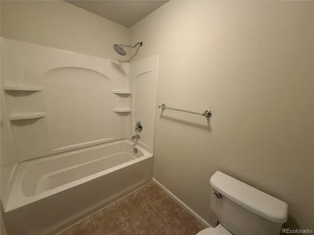a bathroom with a toilet and a bathtub