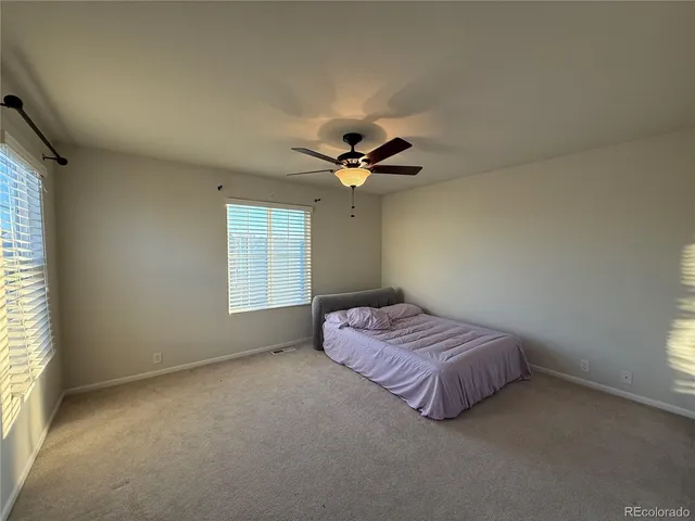 a spacious bedroom with a bed and window