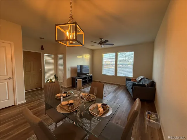 a dining room with furniture and wooden floor