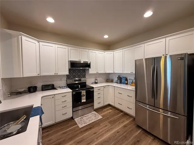 a kitchen with granite countertop stainless steel appliances and wooden cabinets