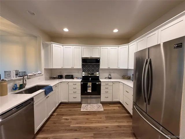 a kitchen with a refrigerator stove and sink