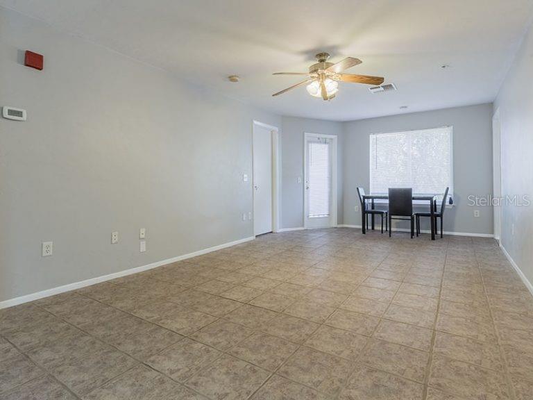4000 Southwest 23rd Street, Unit 3208 #3 Gainesville, FL 32608 - Photo 2 of 17 a view of a livingroom with furniture and chandelier fan