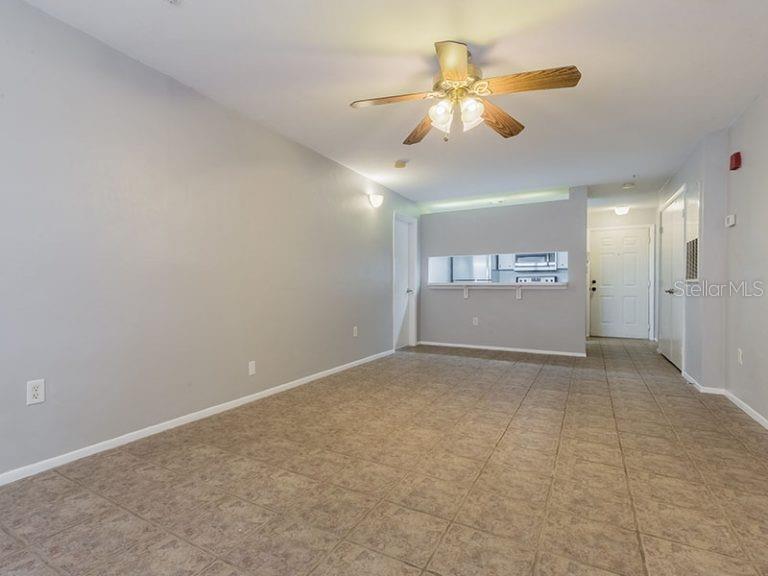 4000 Southwest 23rd Street, Unit 3208 #3 Gainesville, FL 32608 - Photo 3 of 17 an empty room with a chandelier fan and windows