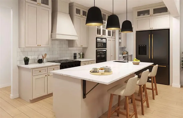 a kitchen with stainless steel appliances kitchen island granite countertop a table chairs and white cabinets