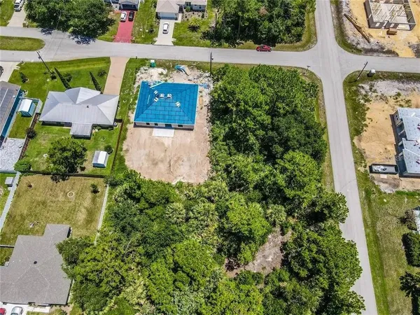an aerial view of a house plants and large trees