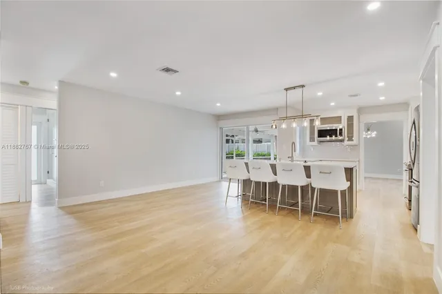 a large kitchen with kitchen island a sink stainless steel appliances and cabinets