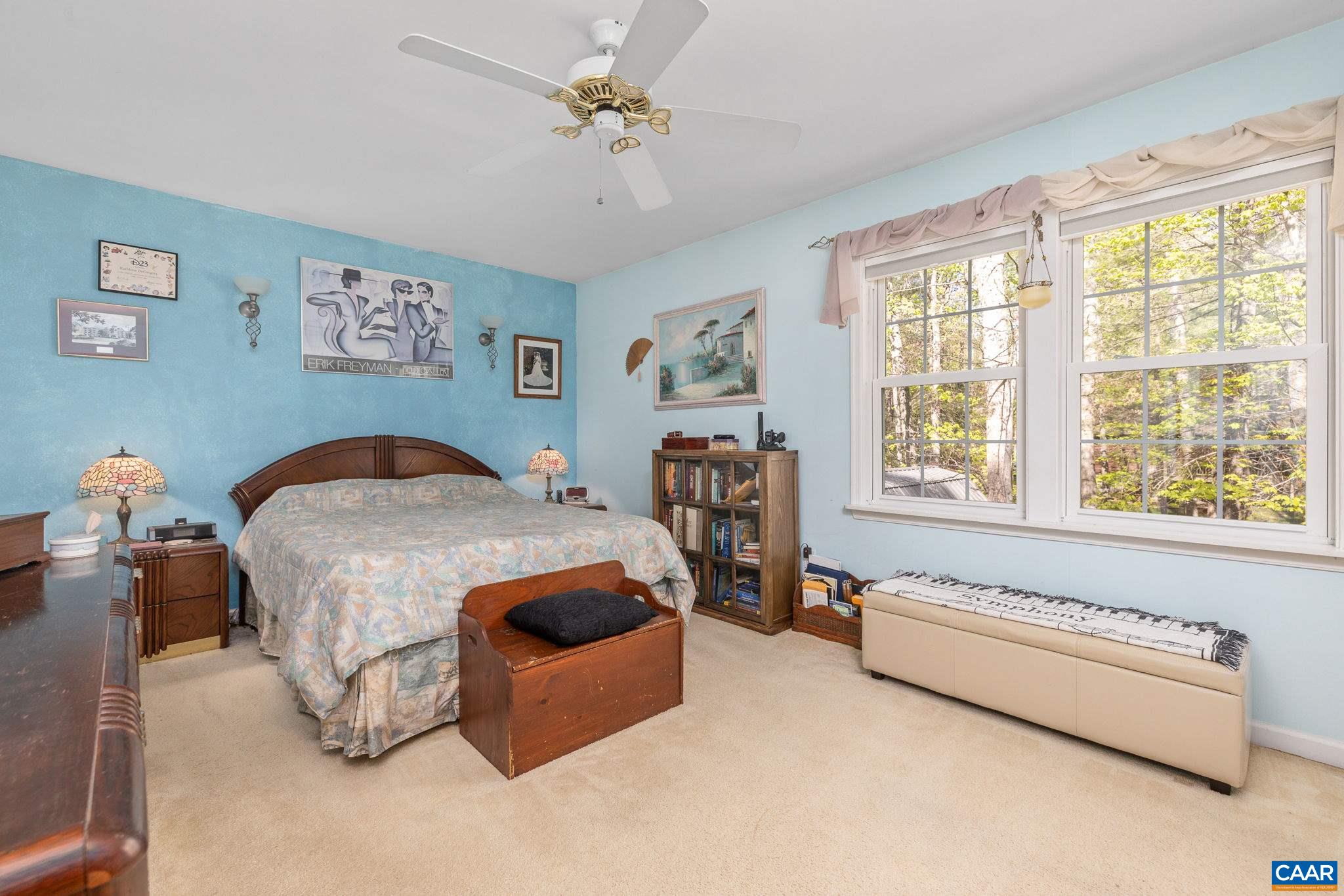 5 Dogleg Road Palmyra, VA 22963 - Photo 38 of 63 a spacious bedroom with a bed a couch and a window