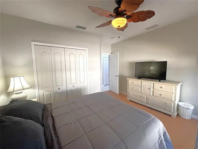 a bedroom with a bed and flat screen tv