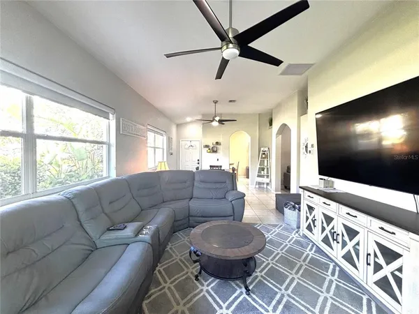 a living room with furniture and a flat screen tv