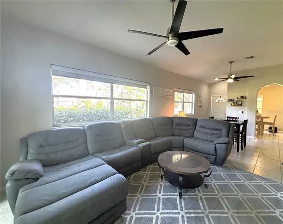 a living room with furniture a window and a chandelier