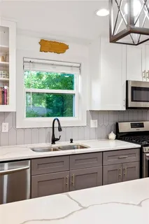 a kitchen with a sink stove and microwave