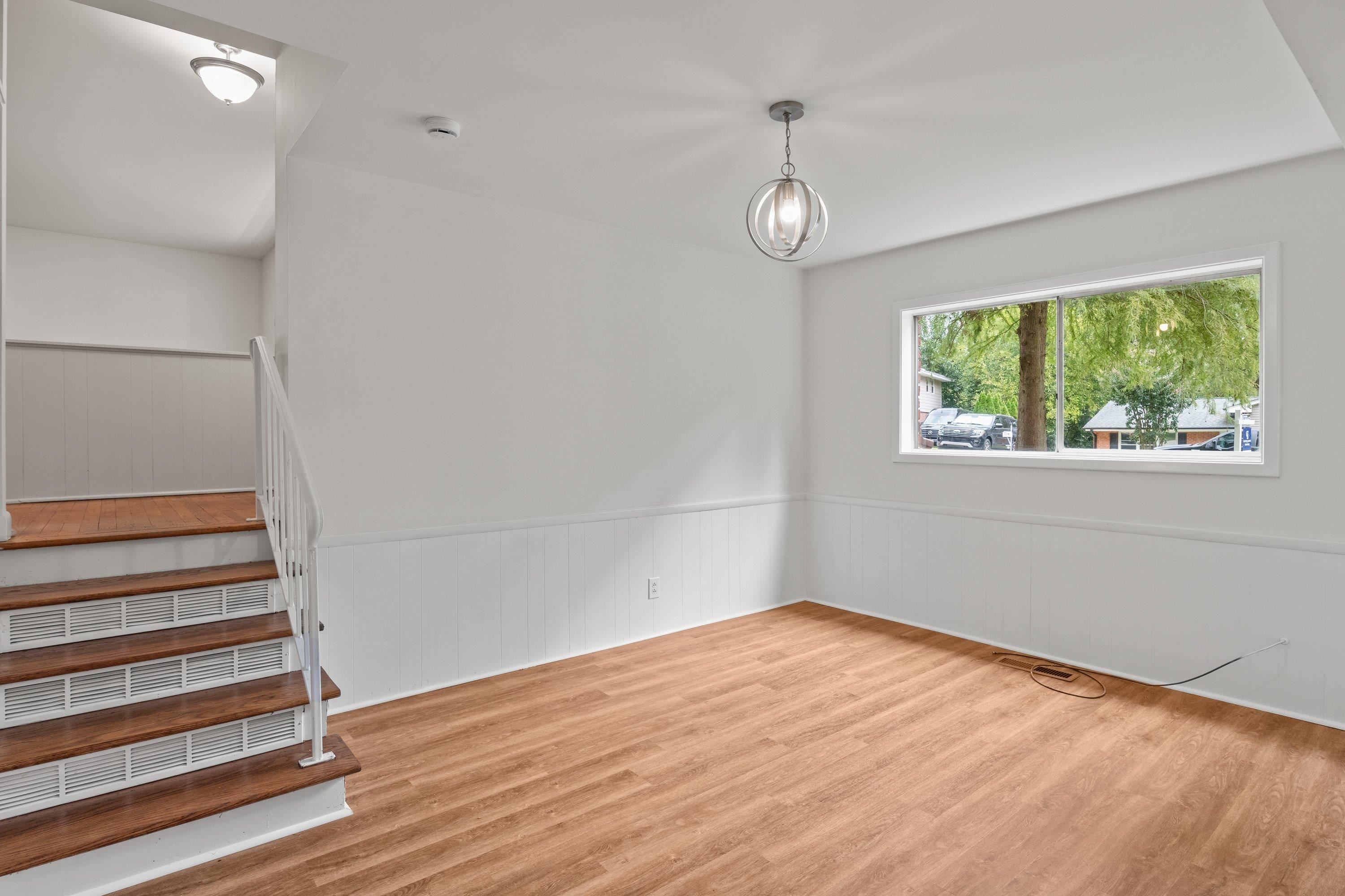 3316 Julian Drive Raleigh, NC 27604 - Photo 11 of 43 an empty room with wooden floor and windows