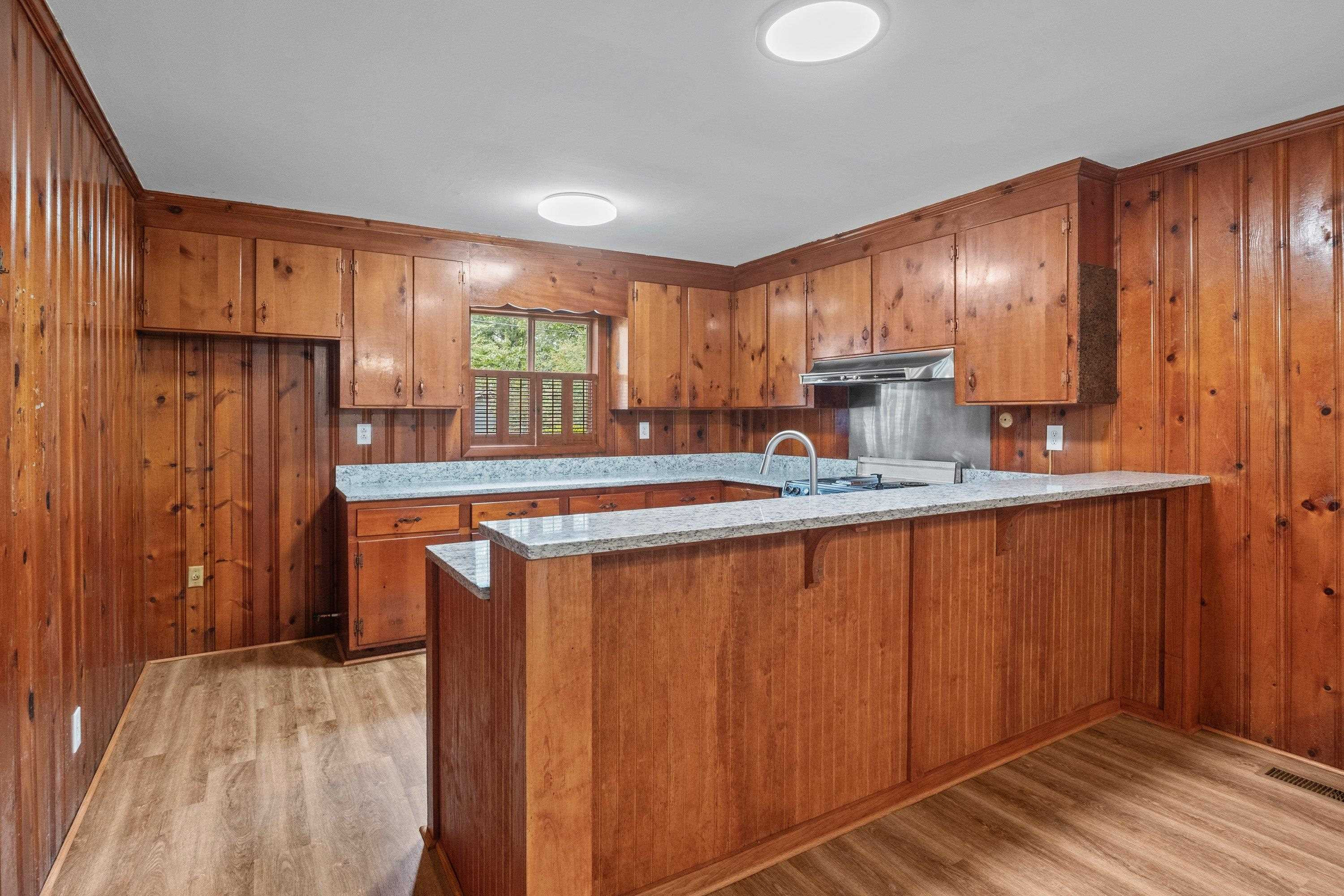 3316 Julian Drive Raleigh, NC 27604 - Photo 18 of 43 a kitchen with stainless steel appliances granite countertop wooden cabinets a sink and a window