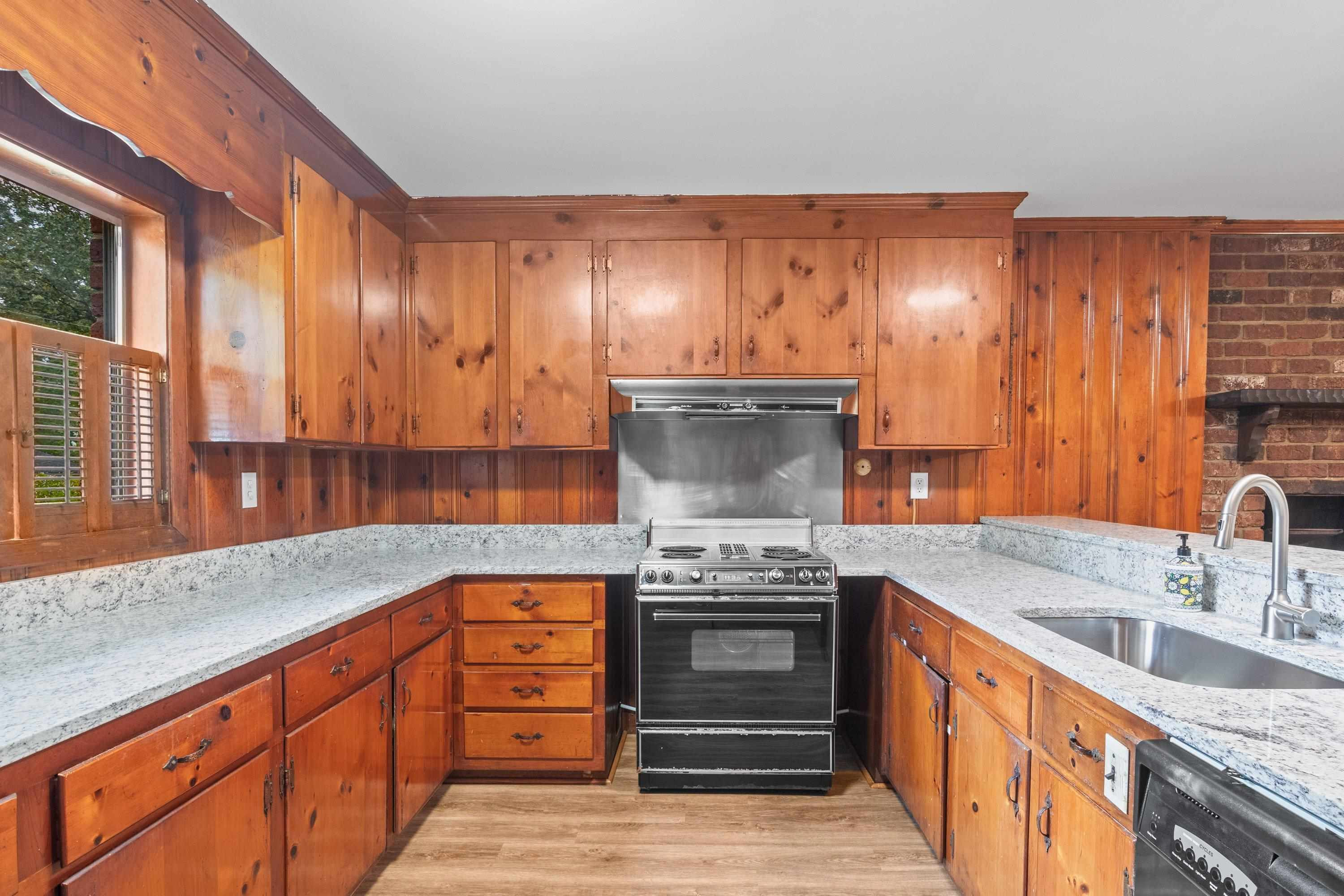 3316 Julian Drive Raleigh, NC 27604 - Photo 20 of 43 a kitchen with stainless steel appliances granite countertop a stove a sink and a microwave