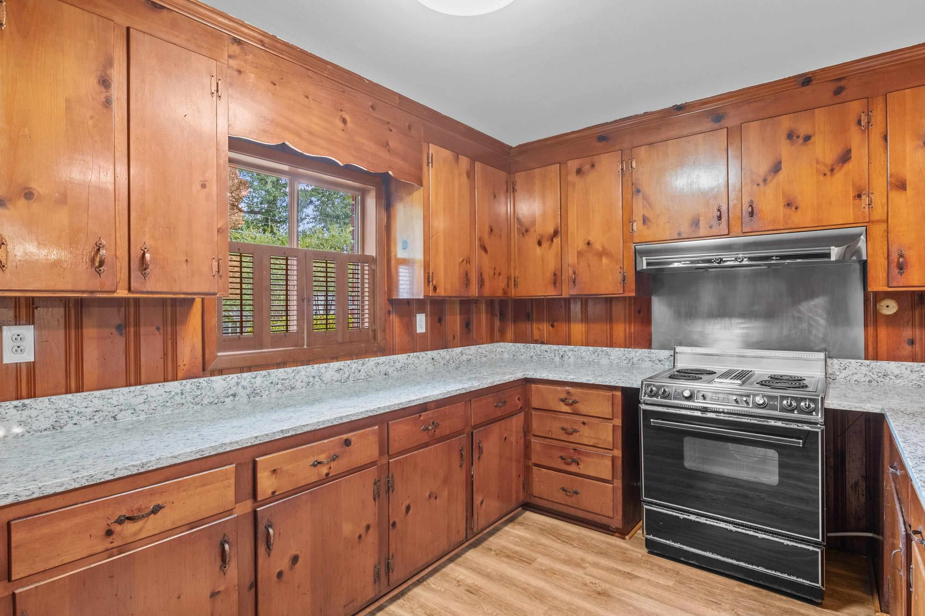 3316 Julian Drive Raleigh, NC 27604 - Photo 21 of 43 a kitchen with granite countertop a stove a sink and a cabinets