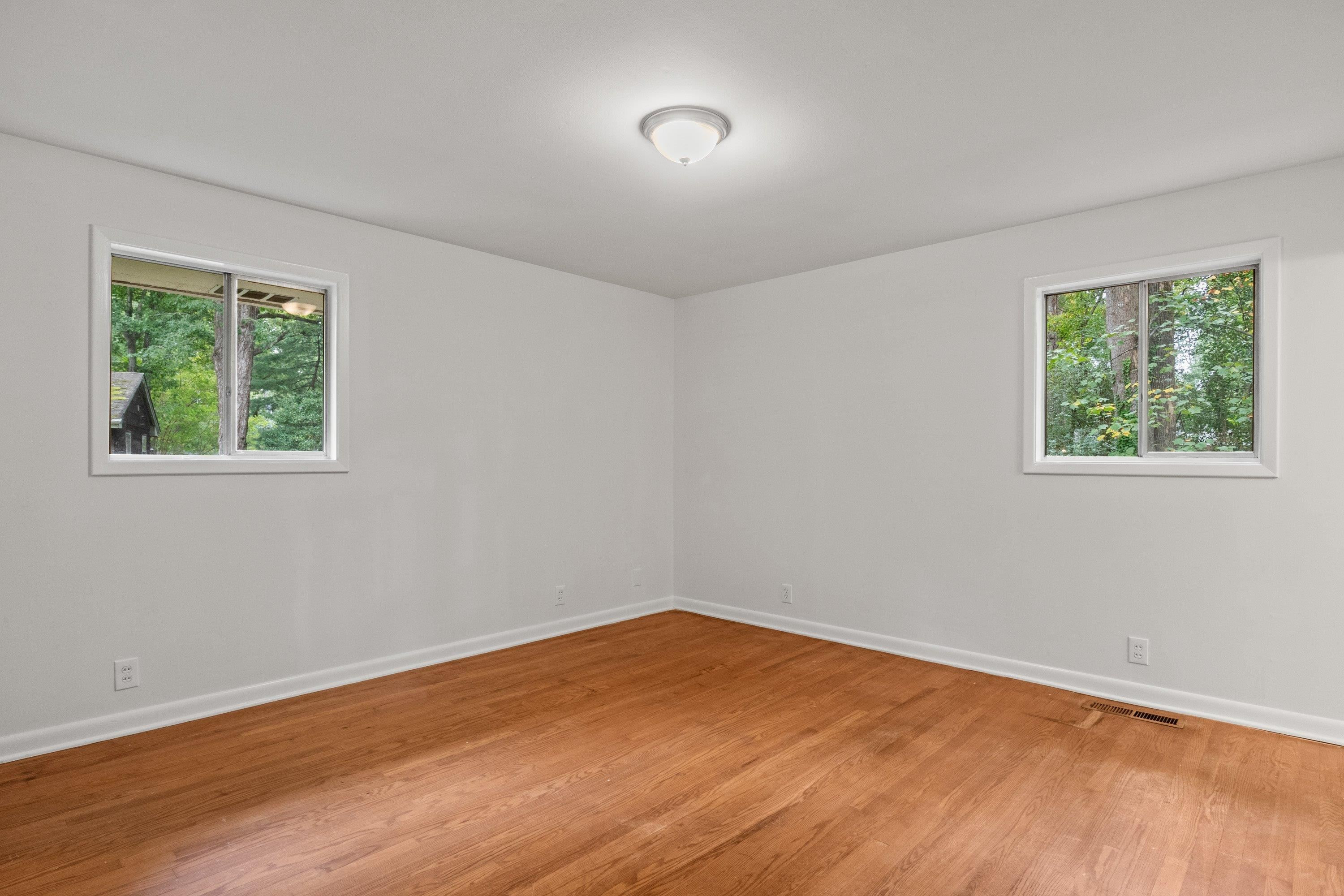 3316 Julian Drive Raleigh, NC 27604 - Photo 30 of 43 a view of an empty room with wooden floor and a window