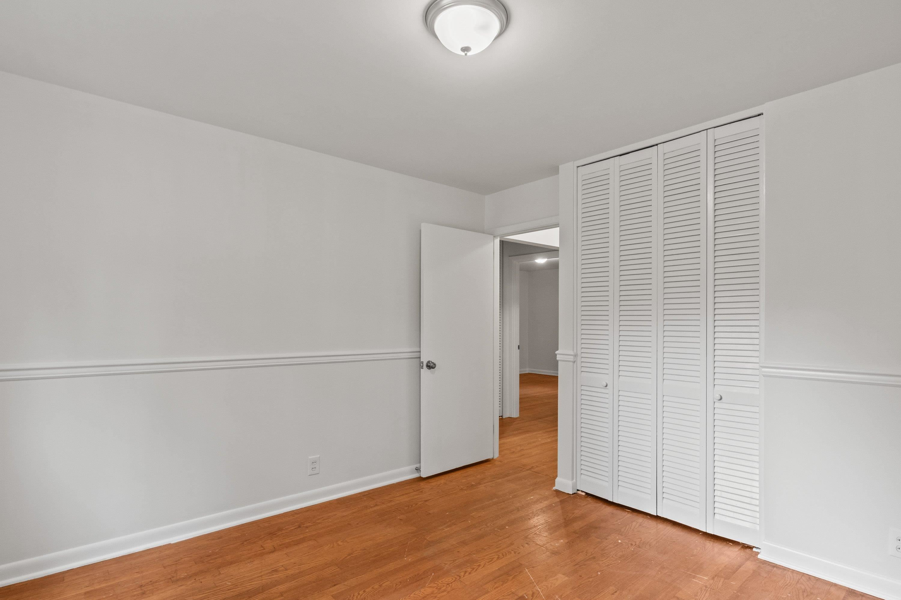 3316 Julian Drive Raleigh, NC 27604 - Photo 33 of 43 an empty room with wooden floor and white walls