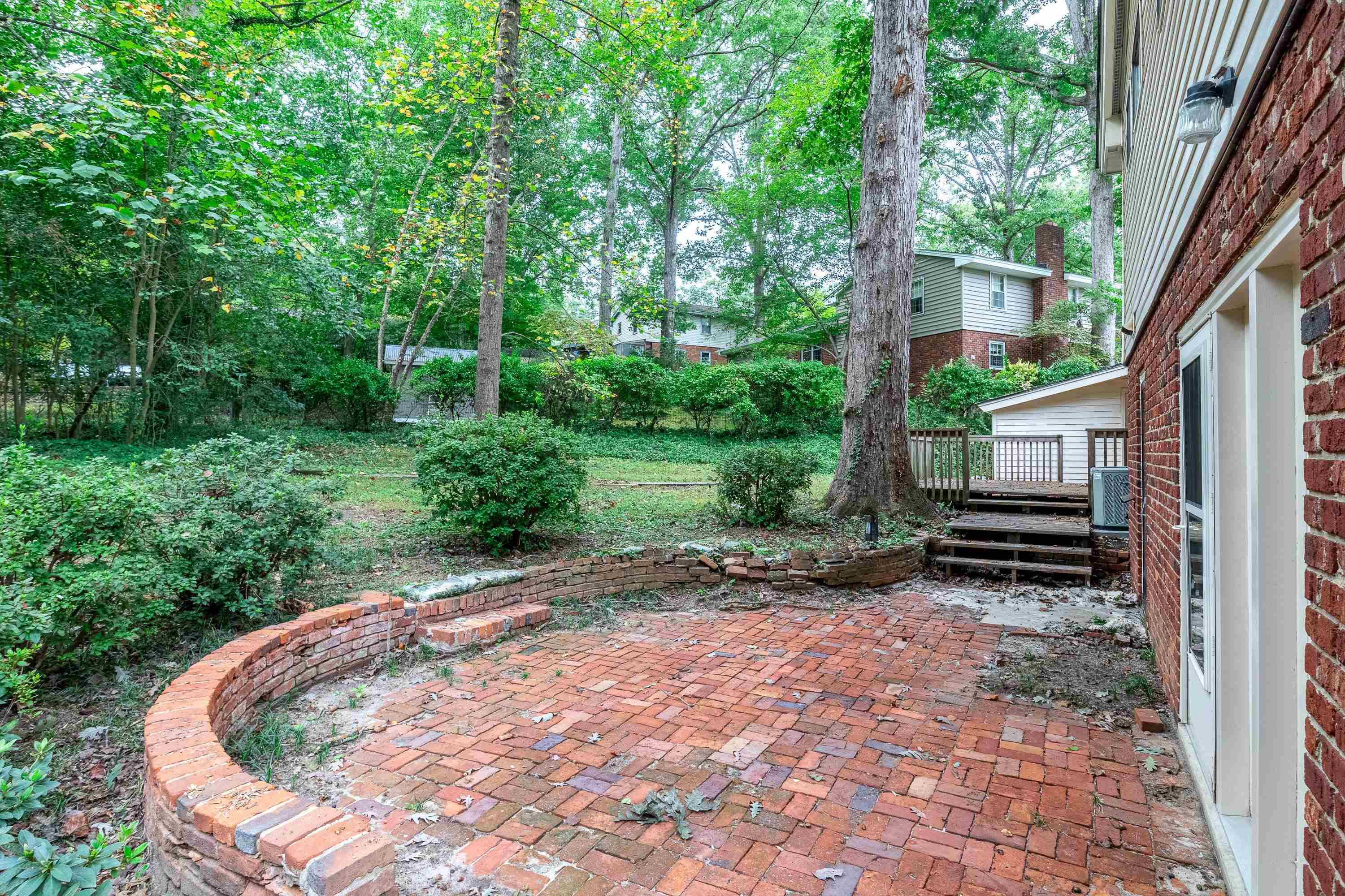 3316 Julian Drive Raleigh, NC 27604 - Photo 41 of 43 a backyard of a house with plants and large trees