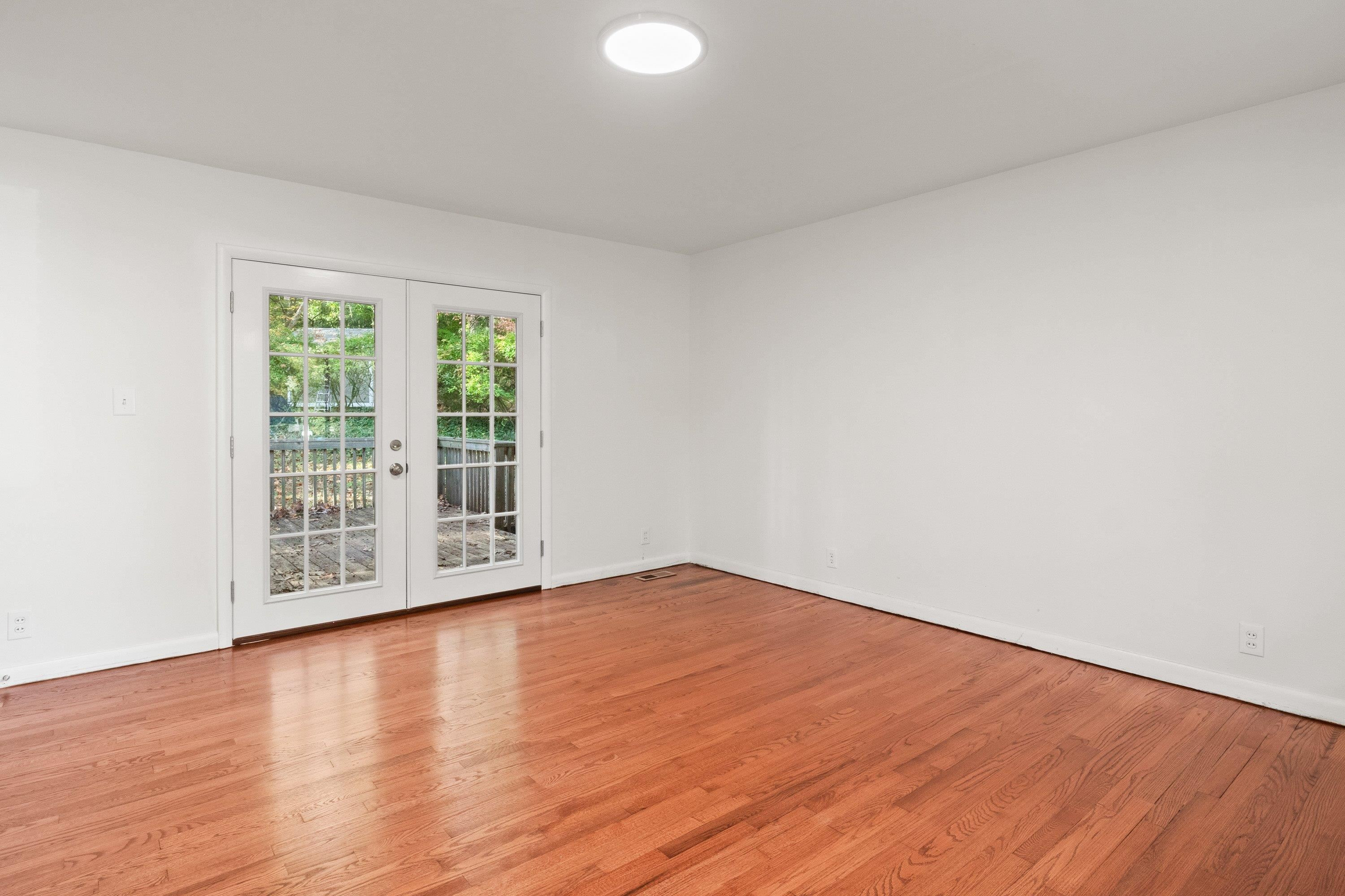 3316 Julian Drive Raleigh, NC 27604 - Photo 9 of 43 a view of an empty room with wooden floor and a window