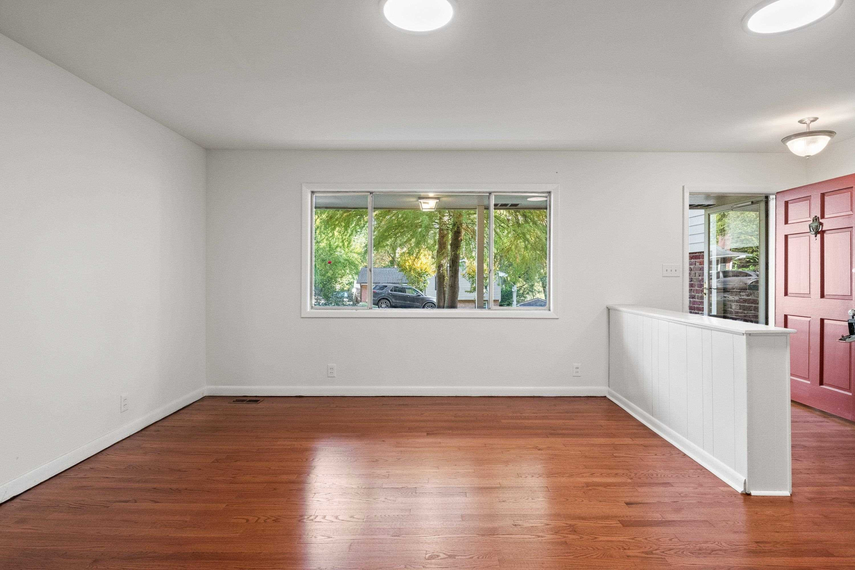 3316 Julian Drive Raleigh, NC 27604 - Photo 10 of 43 an empty room with wooden floor and windows