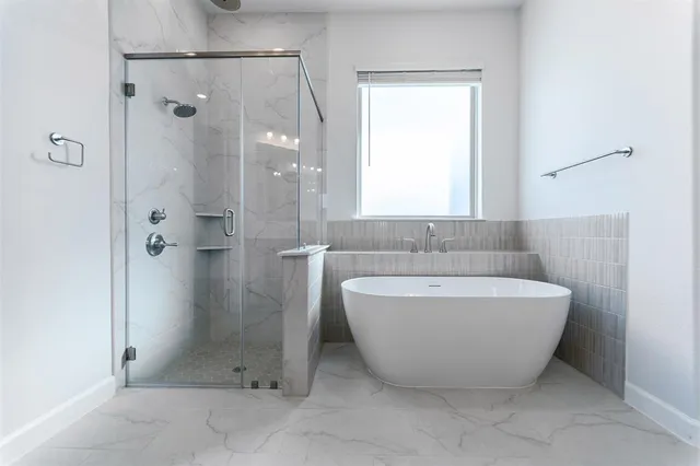 a bathroom with a bathtub and shower