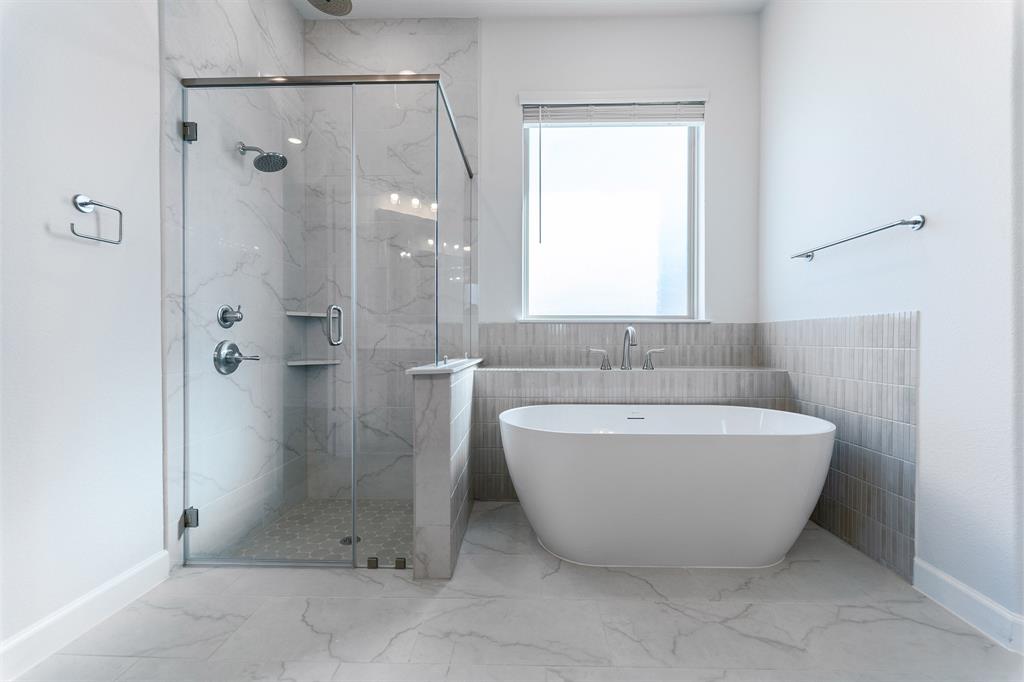 3908 Friendship Court Forney, TX 75126 - Photo 17 of 29 a bathroom with a bathtub and shower