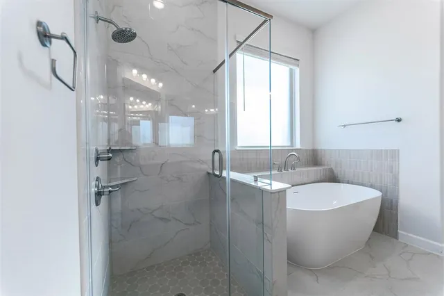 a bathroom with a bathtub sink and mirror