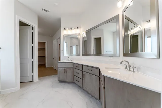 a spacious bathroom with a double vanity sink mirror and