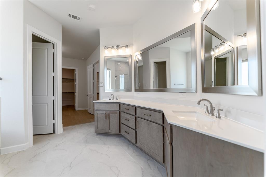 3908 Friendship Court Forney, TX 75126 - Photo 20 of 29 a spacious bathroom with a double vanity sink mirror and