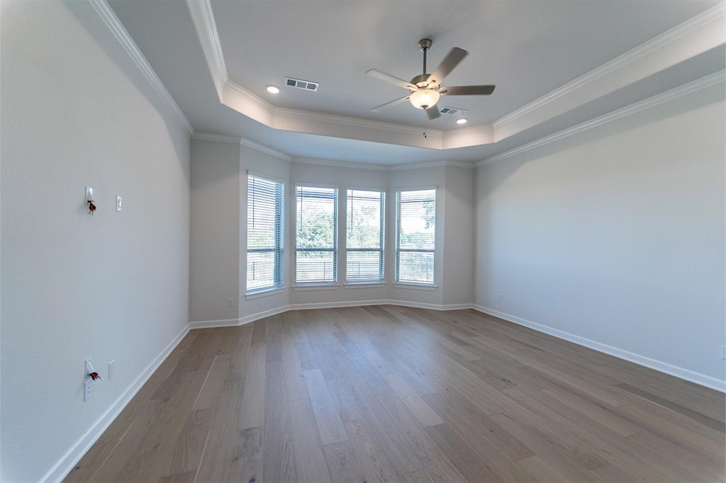 3908 Friendship Court Forney, TX 75126 - Photo 22 of 29 a view of an empty room with wooden floor and a window