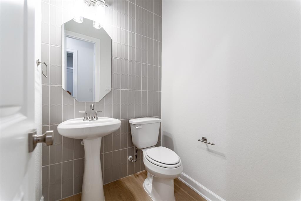 3908 Friendship Court Forney, TX 75126 - Photo 23 of 29 a bathroom with a toilet sink and mirror